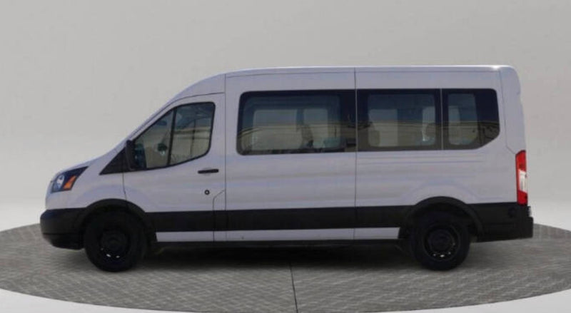Side view of a white passenger van with tinted windows and black trim — photo 1