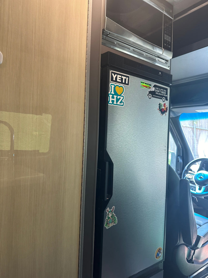  and a picnic table.|Inside this modern RV rental: a well-equipped kitchen counter — photo 3