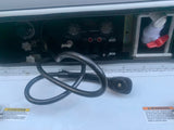 RV rental utility bay showing fresh, gray, and black water tank controls, waste pump, and critical warning labels.