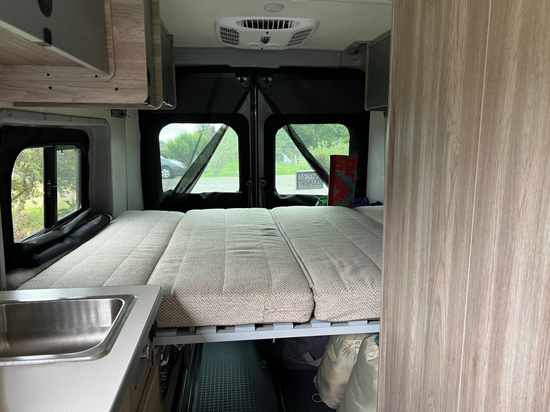  and wood-grained cabinet. Efficient camper design.|RV rental van interior. Modern dashboard with large touchscreen infotainment — photo 14