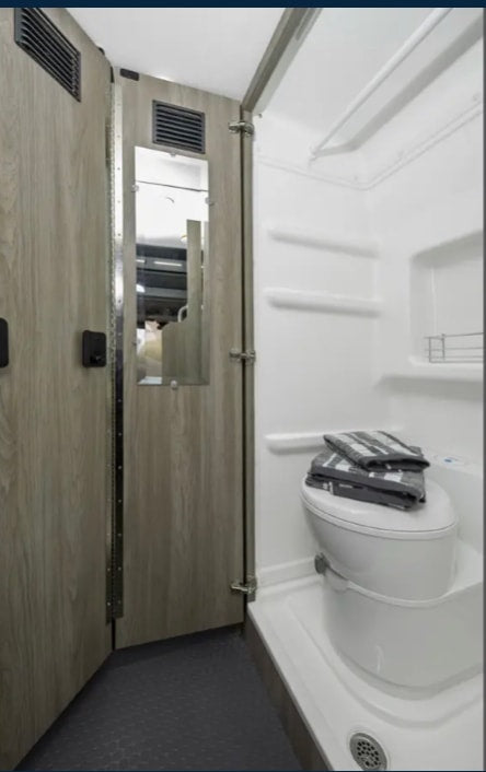  perfect for meals on the road.|Cozy RV rental interior: A person relaxes on a bed