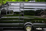 Sleek black RV rental: side view of a camper van with a ladder & roof rack, ready for adventure.