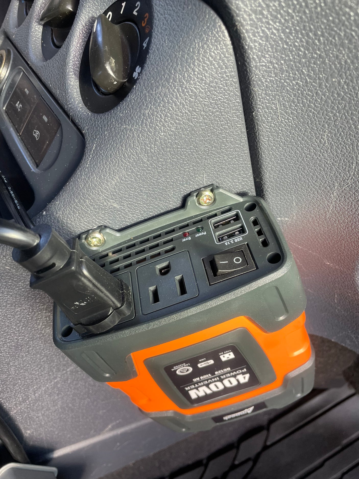 A 400W power inverter with AC outlet and USB ports installed in an rv rental for charging devices.