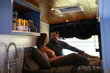  and matching mugs await your adventure.|Woman stands by an open blue camper van RV rental