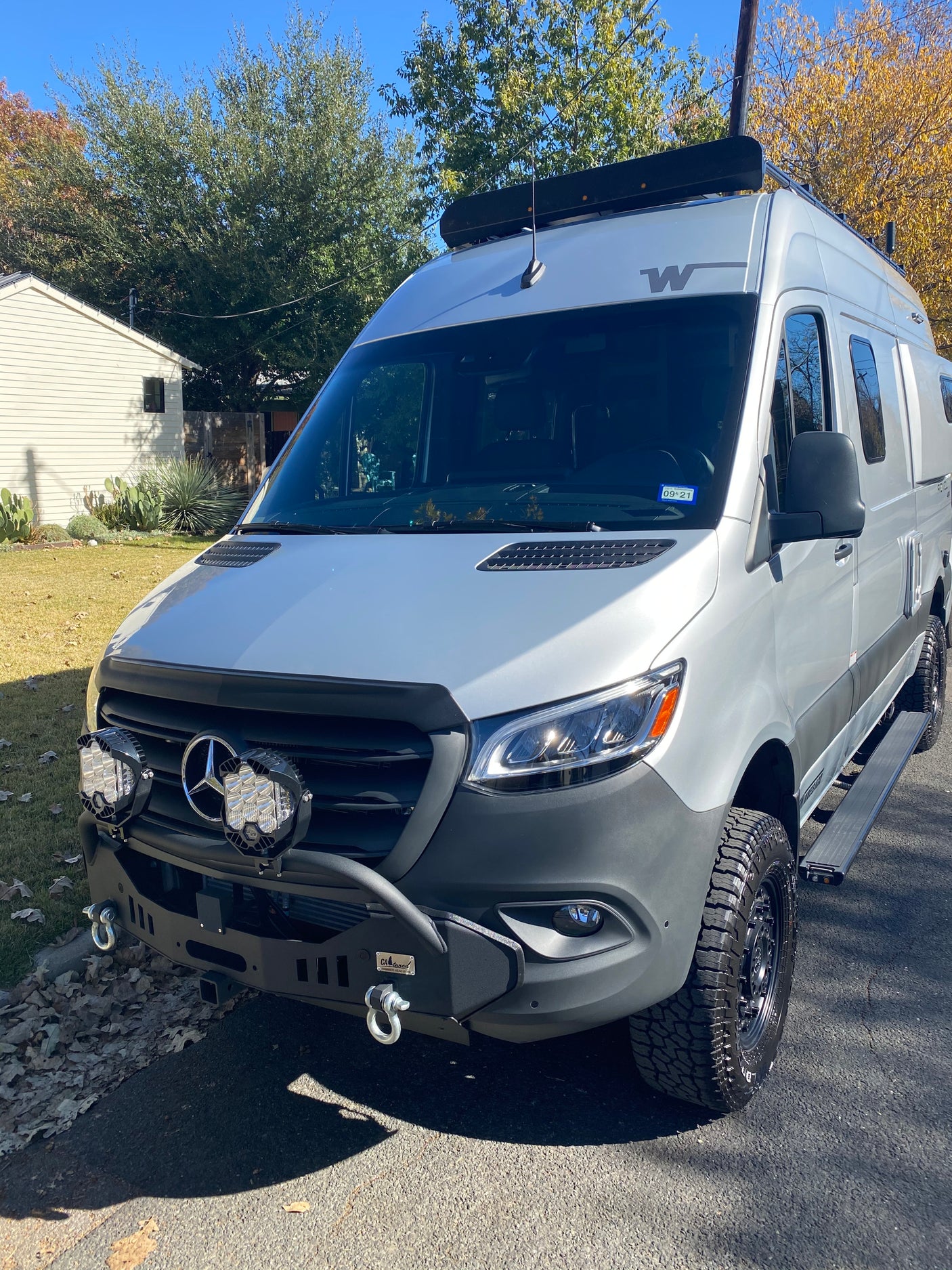 Rugged Mercedes-Benz Sprinter rv rental, perfect for adventure. Features custom bumper, auxiliary lights, and roof rack.
