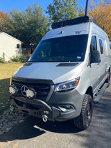 Rugged Mercedes-Benz Sprinter rv rental, perfect for adventure. Features custom bumper, auxiliary lights, and roof rack.
