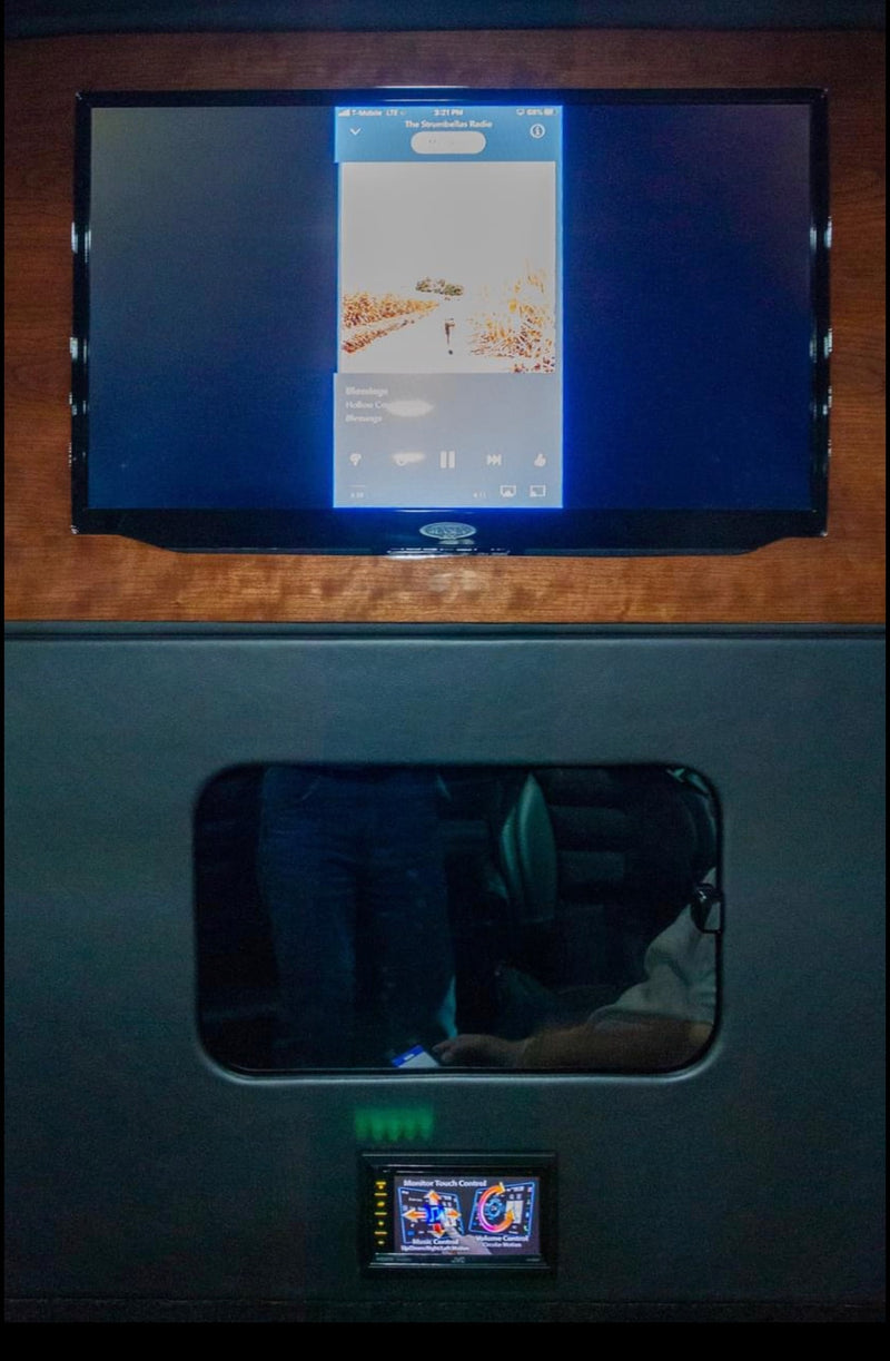 RV rental interior featuring a flat-screen displaying a music app and a JVC monitor for touch control. Comfort and entertainment. — photo 6