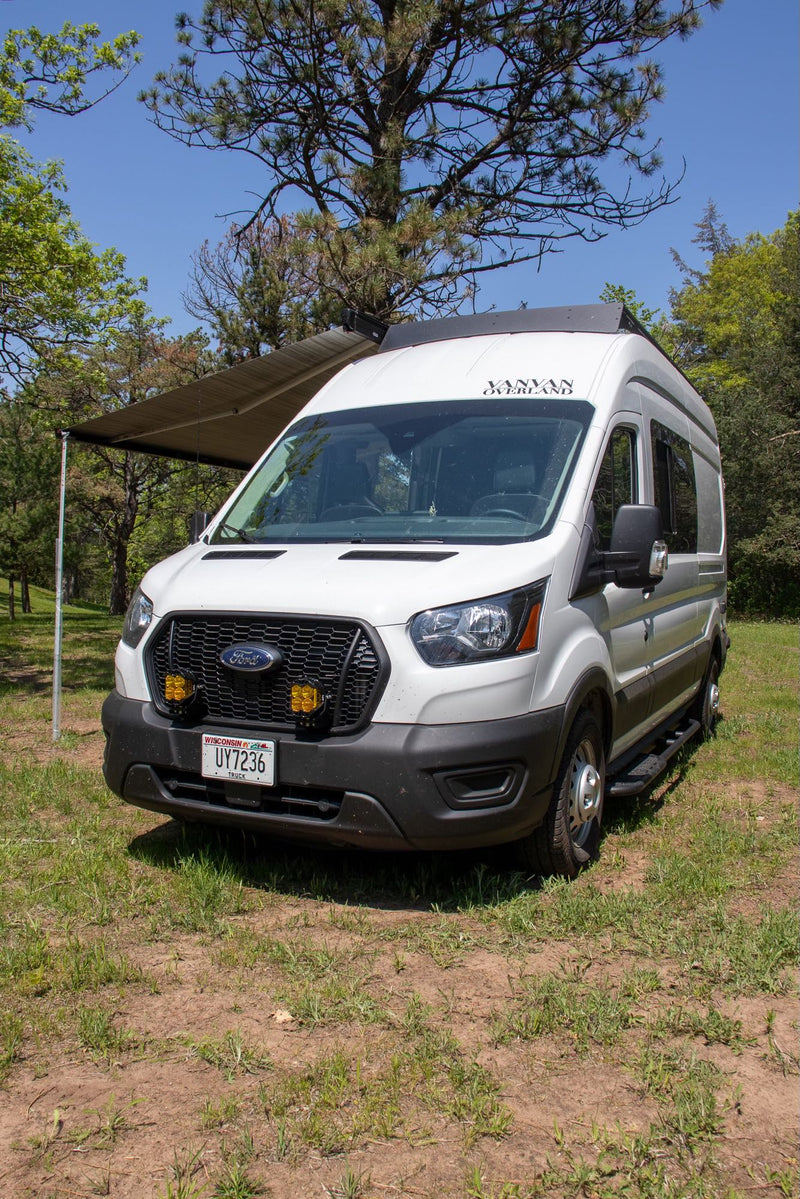 White Ford Transit camper van RV rental with awning extended — photo 1