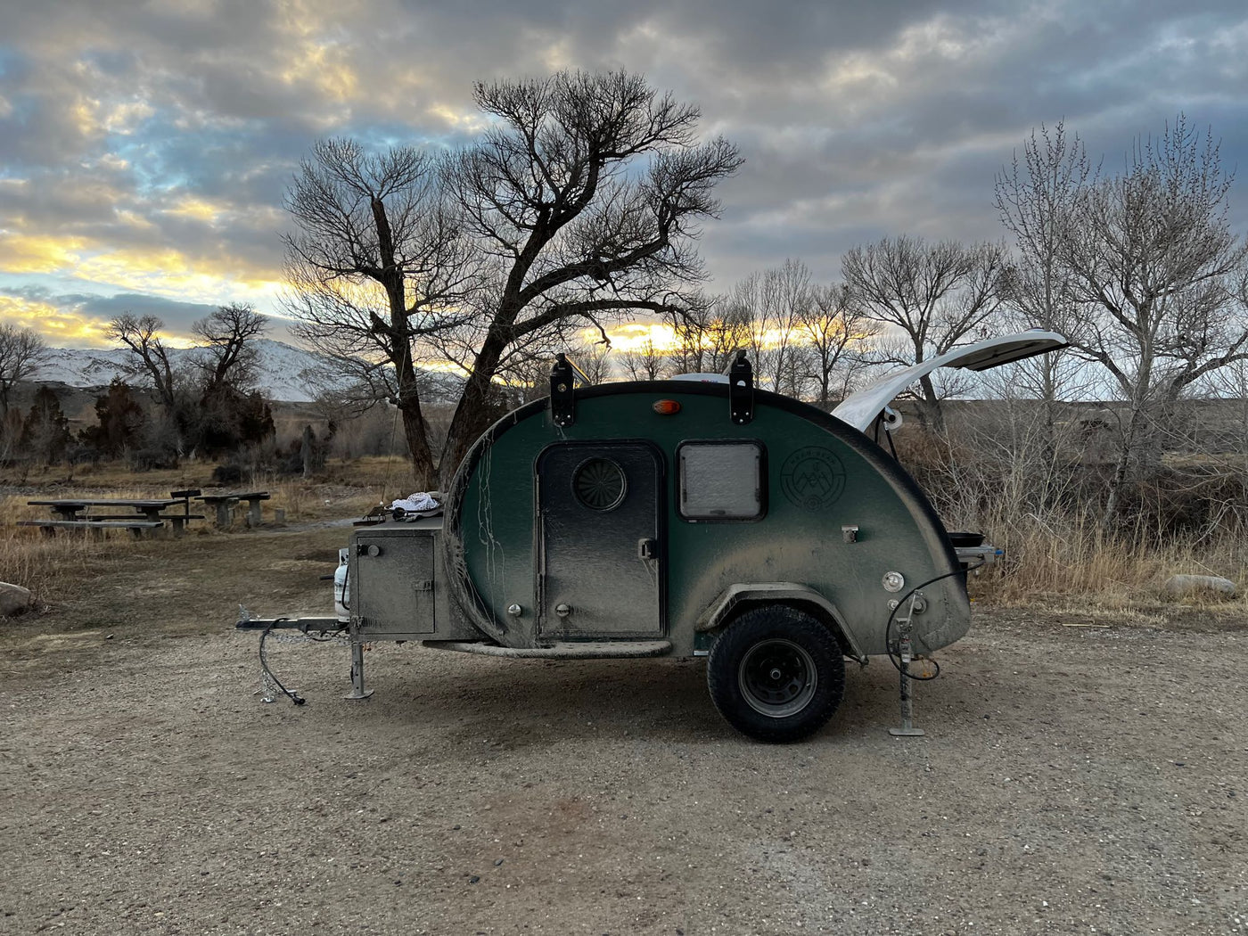  and door.|An off-road teardrop camper with a blue-lit outdoor kitchen. Perfect RV rental for rugged adventures.|This dusty — photo 9