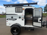This Sunray Sport travel trailer is a compact RV rental, ideal for adventure. It features an awning & rugged off-road tires.