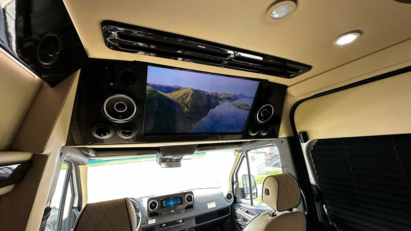 Enjoy a movie in this luxury rv rental, equipped with a large screen, premium audio, and comfortable seating. — photo 9