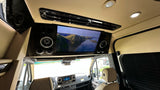Enjoy a movie in this luxury rv rental, equipped with a large screen, premium audio, and comfortable seating.