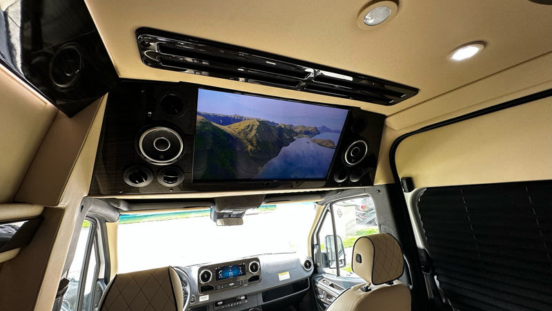 Enjoy a movie in this luxury rv rental, equipped with a large screen, premium audio, and comfortable seating. — photo 9