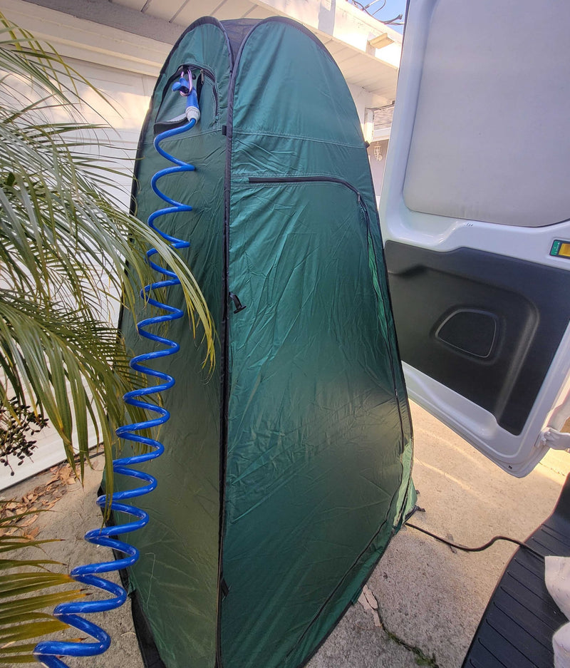 Green privacy tent with coiled blue shower hose & power cord, ideal for an RV rental outdoor shower setup. — photo 16