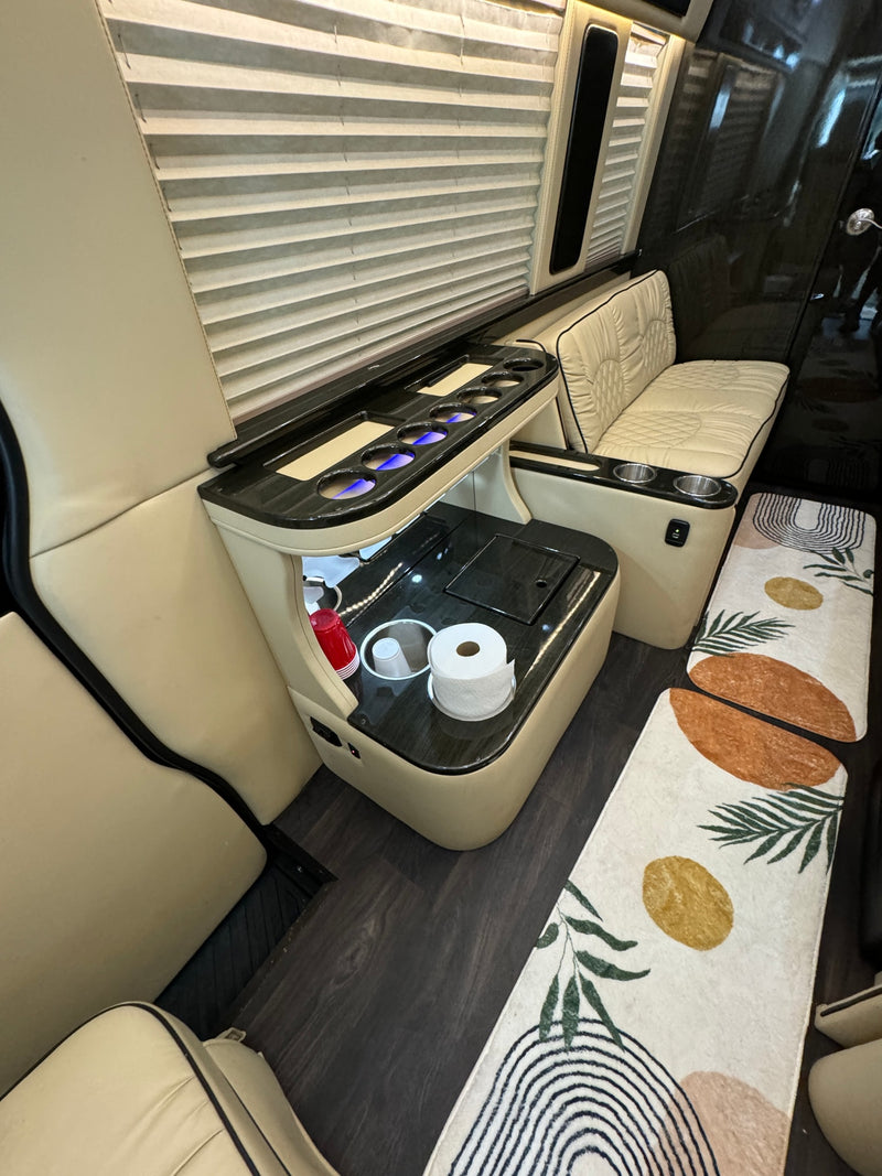 Experience comfort in this RV rental! Plush cream interior, bespoke console with lighting, and artistic floor mats. — photo 9