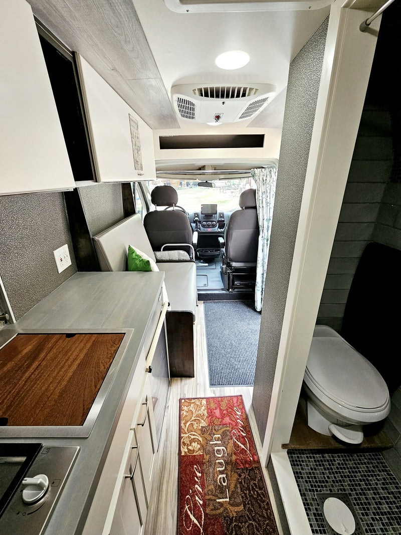  parked on a gravel road.|White Ram ProMaster camper van on a gravel road — photo 11
