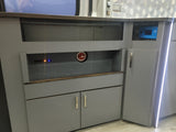 Modern RV rental interior with custom gray cabinets, essential power controls, and a sleek backsplash, perfect for adventure.