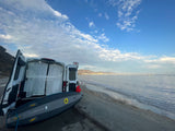 Beachside RV rental with paddleboard. Perfect for coastal travel, offering ocean views & outdoor activities.