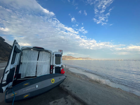 Beachside RV rental with paddleboard. Perfect for coastal travel, offering ocean views & outdoor activities.