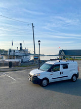 White RV rental van at Moosehead Marine Museum with the historic Katahdin steamboat. Great for waterfront travel!