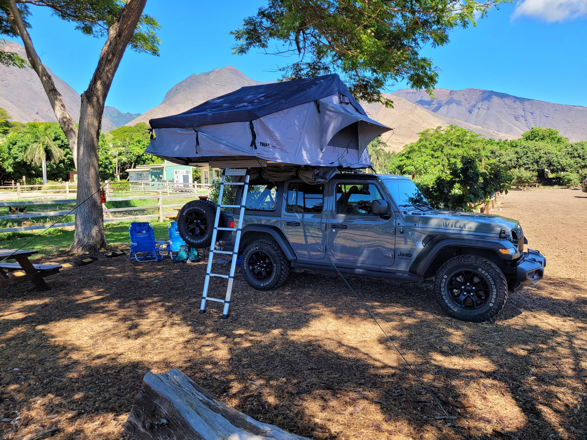 This Jeep Wrangler with a Thule Tepui rooftop tent offers a unique rv rental for outdoor adventures and mountain camping. — photo 6