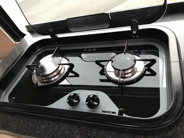  ready for a memorable travel adventure.|Modern two-burner gas stove in an RV rental