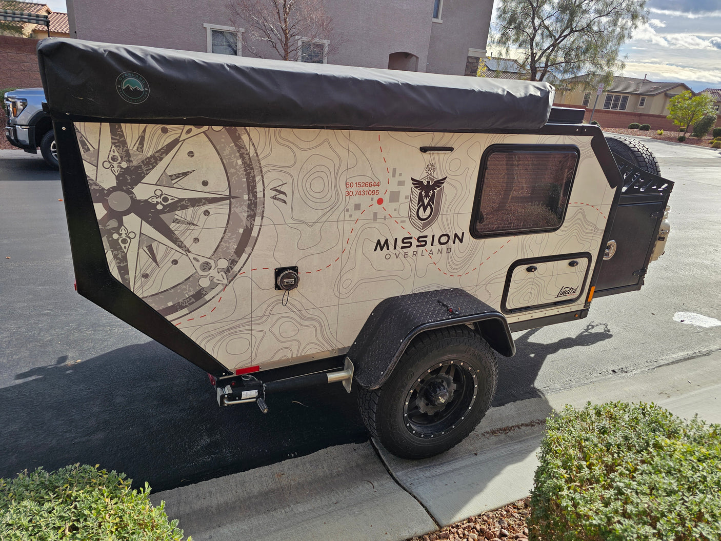 Ready for adventure! This Mission Overland off-road camping trailer, ideal for an RV rental, features unique map graphics.