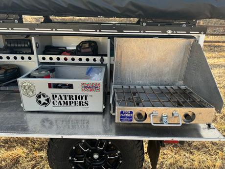 Overlanding kitchen setup: pull-out stove, storage for a Patriot Campers box. Perfect for your rv rental adventure.