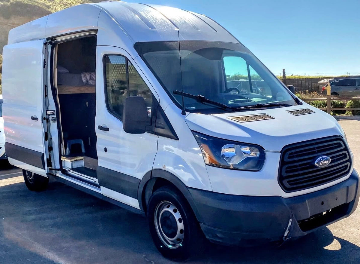  and clever pull-out toilet system.|An RV rental van's open side door reveals a dividing door and a window AC unit — photo 6