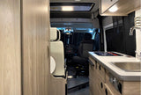 Experience adventure with this spacious rv rental. View of camper van interior showing kitchen, swivel seating, and cockpit.