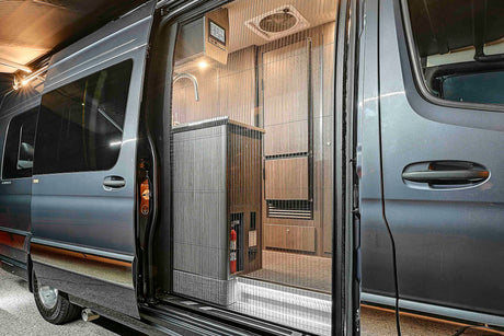 A sleek rv rental camper van with its side door open, revealing a functional interior & screen door for adventure.