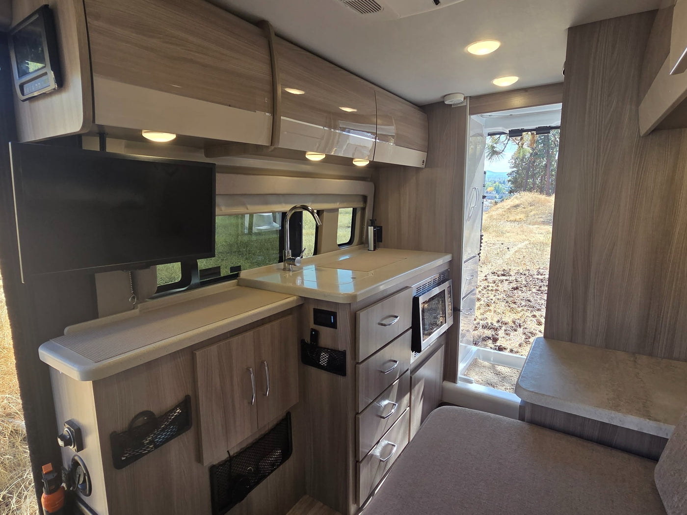  and a table. View of nature outside.|Inside a clean rv rental: front swivel seats — photo 20