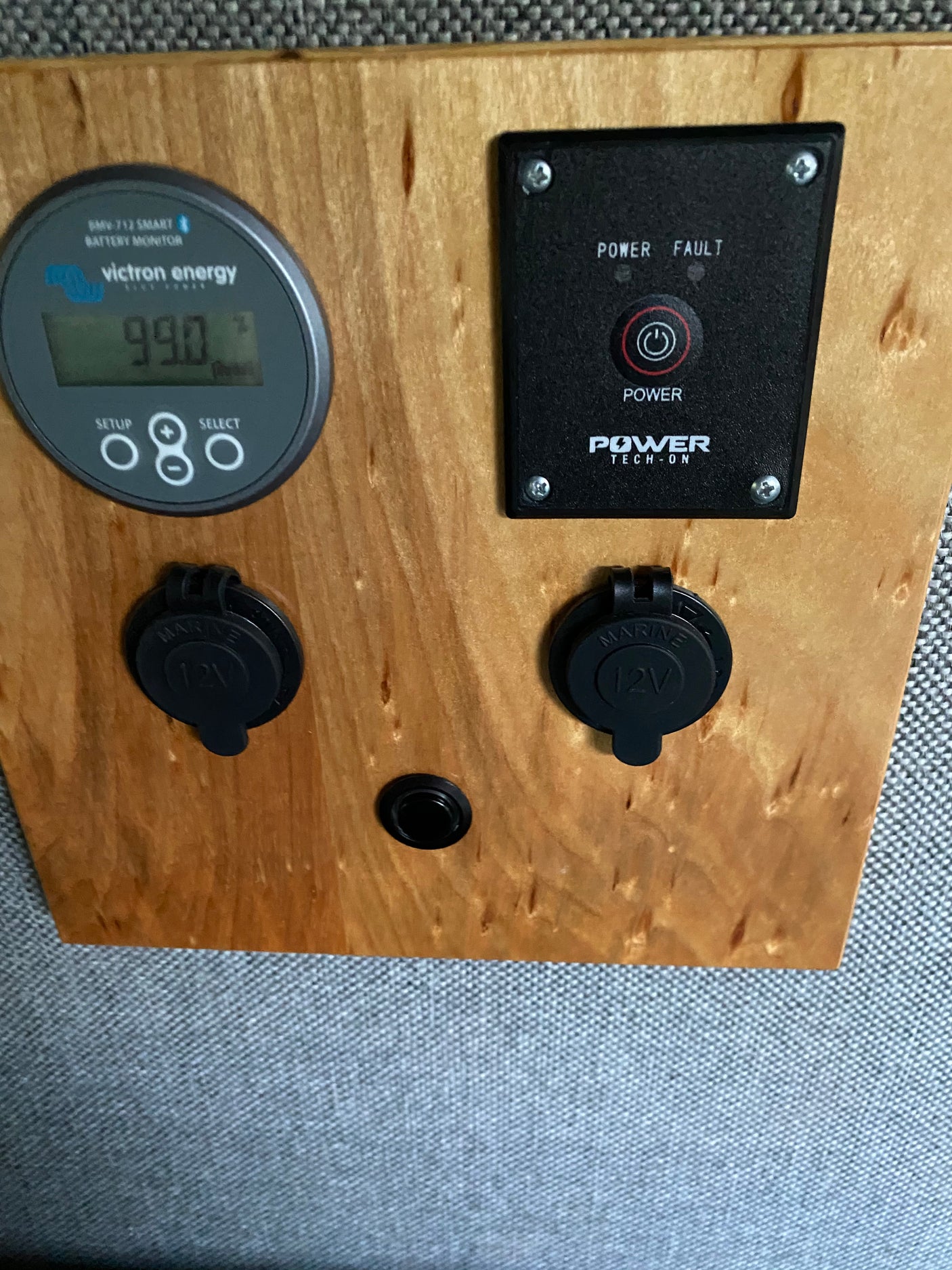 RV rental power panel with Victron battery monitor, power controls, and 12V outlets for camper power.