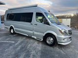 Silver Airstream RV rental: a modern camper van parked, ready for adventure and travel.