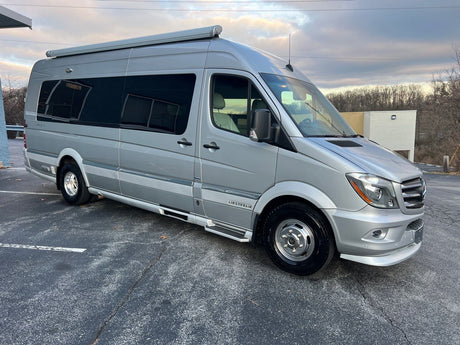 Silver Airstream RV rental: a modern camper van parked, ready for adventure and travel.