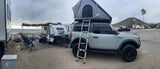 Beachside RV rental setup: a Bronco with rooftop tent & Sunray teardrop trailer for an adventurous camping trip.