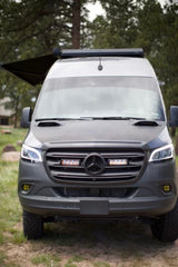 Experience adventure with this rugged Mercedes Sprinter camper van RV rental, ready for exploration with its extended awning.