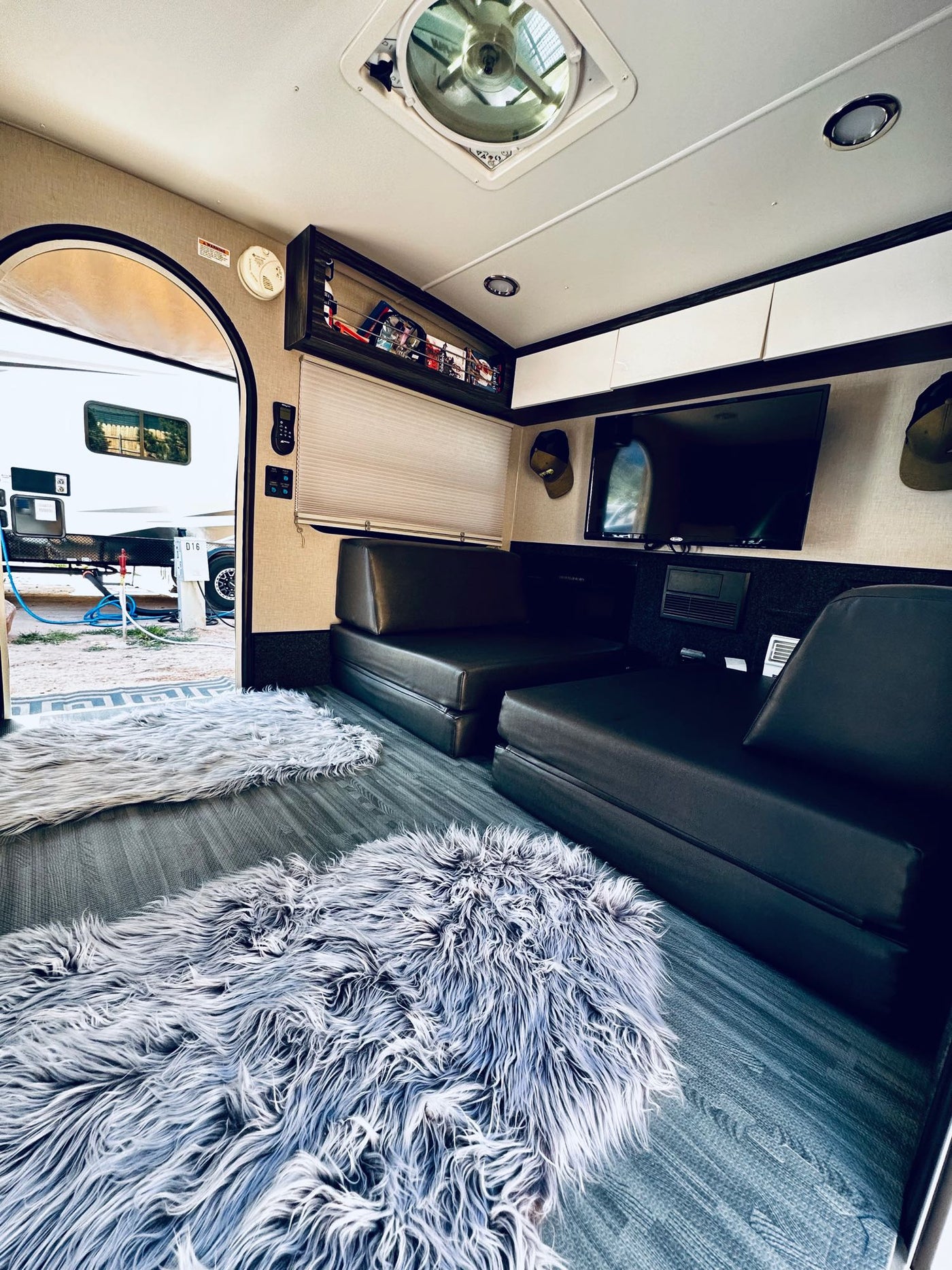  parked beside an SUV at a sunny campsite.|This teardrop RV rental showcases its functional outdoor kitchen — photo 10