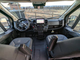 Step into this RV rental! Driver's view of a camper van's modern cockpit, dashboard screen, and outdoor scenic landscape.