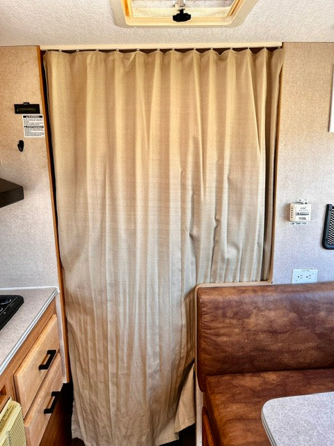  and storage.|A couple enjoys playing cards and a beer inside their RV rental — photo 11