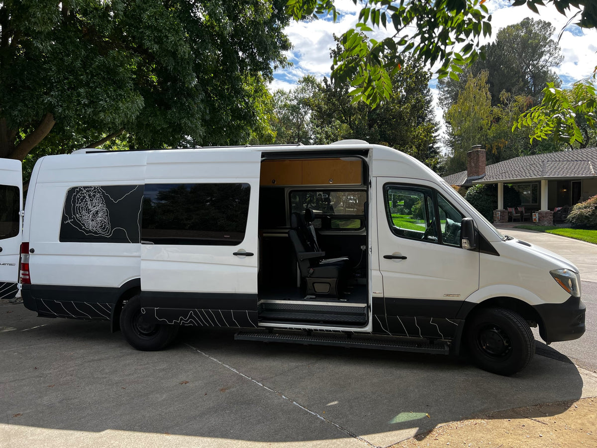  offering a view of a sunny residential street and trees.|RV rental with solar panels and roof vent — photo 9