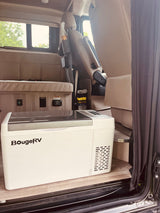 RV rental interior featuring a BougeRV portable fridge, cozy seating, and essential power outlets for travel adventures.
