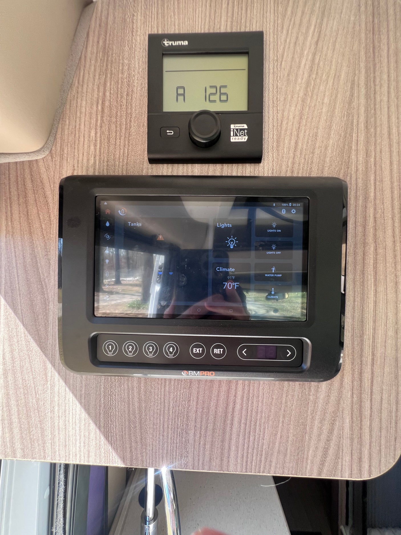 RV rental control panels: Truma thermostat & BMPRO smart system managing climate, lights, water pump, and tanks.
