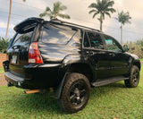 A black SUV, ideal for exploring Hawaii's landscapes, parked on grass. A great travel option, perhaps alongside an rv rental.
