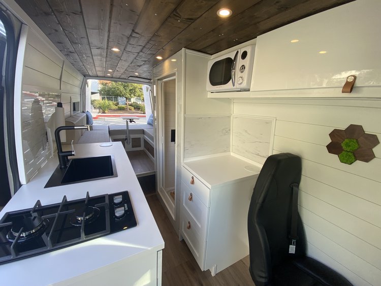  and comfortable seating.|A light-colored customized Mercedes-Benz Sprinter camper van — photo 11