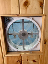 RV rental interior: White ceiling fan with mesh screen & controls in natural wooden paneling, providing fresh air.