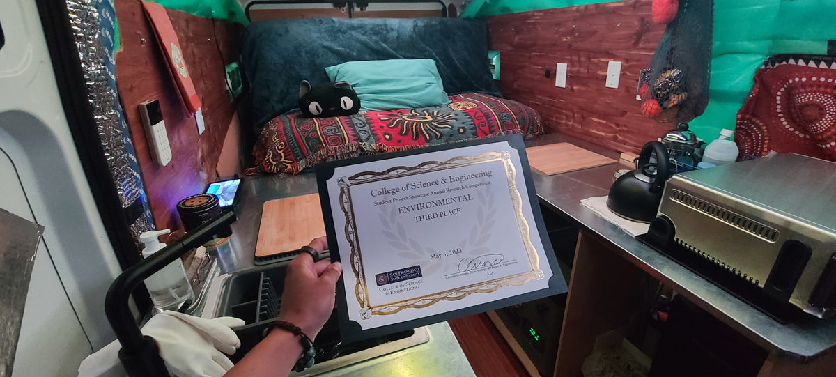 Inside an rv rental, a person holds an environmental third-place award from SF State's College of Science & Engineering. — photo 18