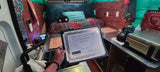 Inside an rv rental, a person holds an environmental third-place award from SF State's College of Science & Engineering.