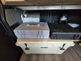 RV rental camp setup: Yeti cooler, SPRK grill, water tank, propane, & portable toilet for convenience.