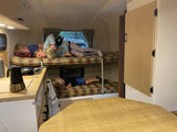 Cozy RV rental interior with bunk beds, kitchen, and kids relaxing. Perfect for family adventures!